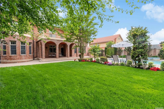 view of yard featuring a patio area and a balcony