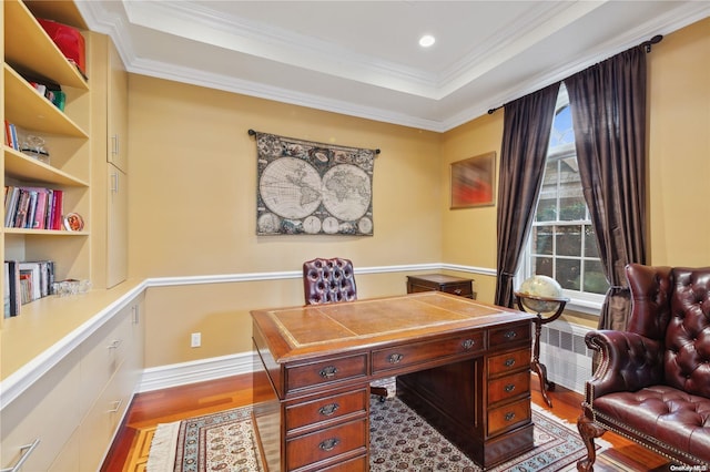 home office featuring light hardwood / wood-style floors, a raised ceiling, radiator, and ornamental molding