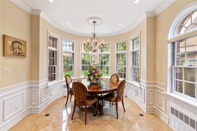 dining room with radiator, ornamental molding, and a notable chandelier