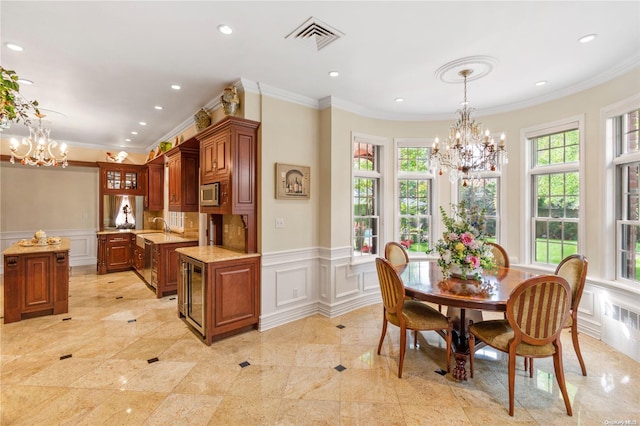 dining room with radiator heating unit, sink, crown molding, and a notable chandelier