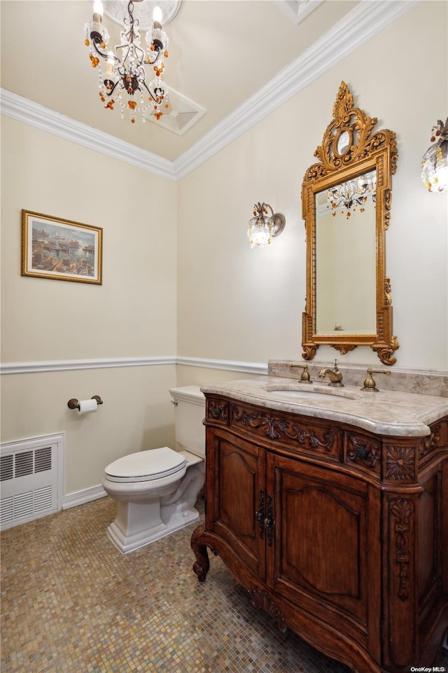 bathroom with vanity, toilet, crown molding, and radiator