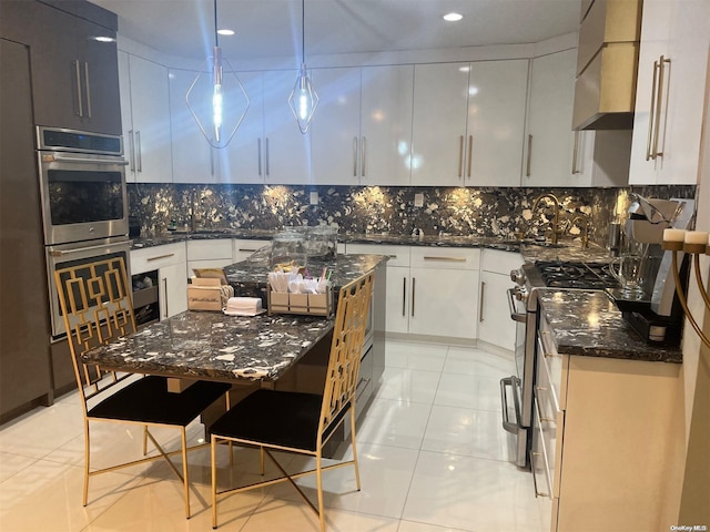 kitchen with appliances with stainless steel finishes, light tile patterned floors, pendant lighting, dark stone countertops, and white cabinets