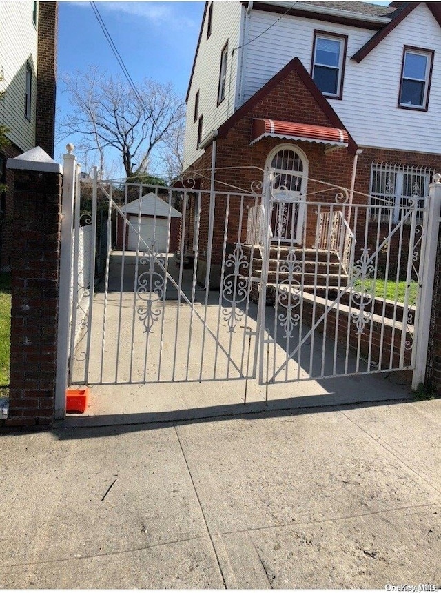 view of gate with an outbuilding