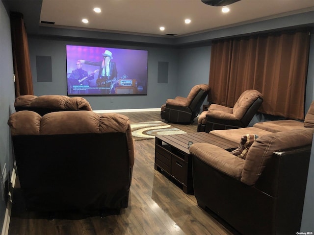 home theater featuring visible vents, a tray ceiling, recessed lighting, baseboards, and dark wood-style flooring