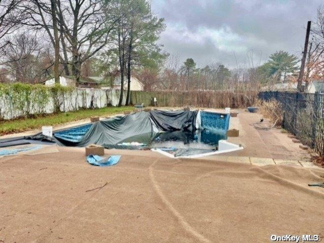 view of swimming pool with a fenced in pool and fence