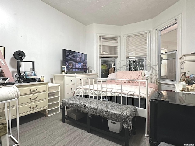 bedroom with hardwood / wood-style flooring