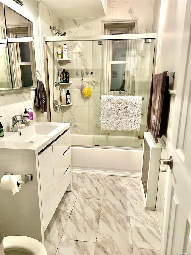 full bathroom with vanity, toilet, and bath / shower combo with glass door