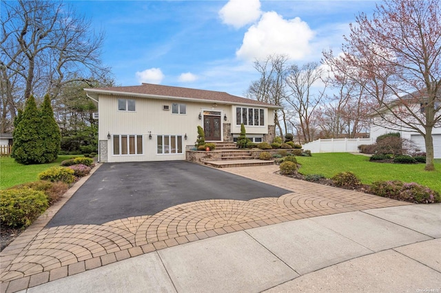 split foyer home with a front lawn