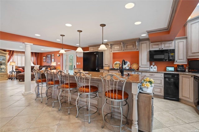 kitchen featuring light tile patterned floors, light stone counters, black appliances, a kitchen bar, and ornate columns