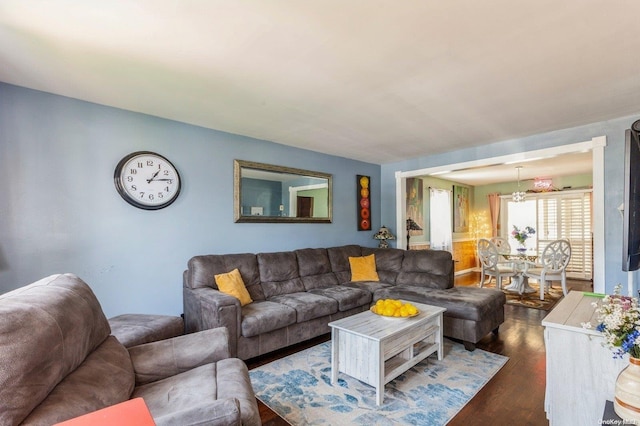 living room with dark hardwood / wood-style floors and a notable chandelier