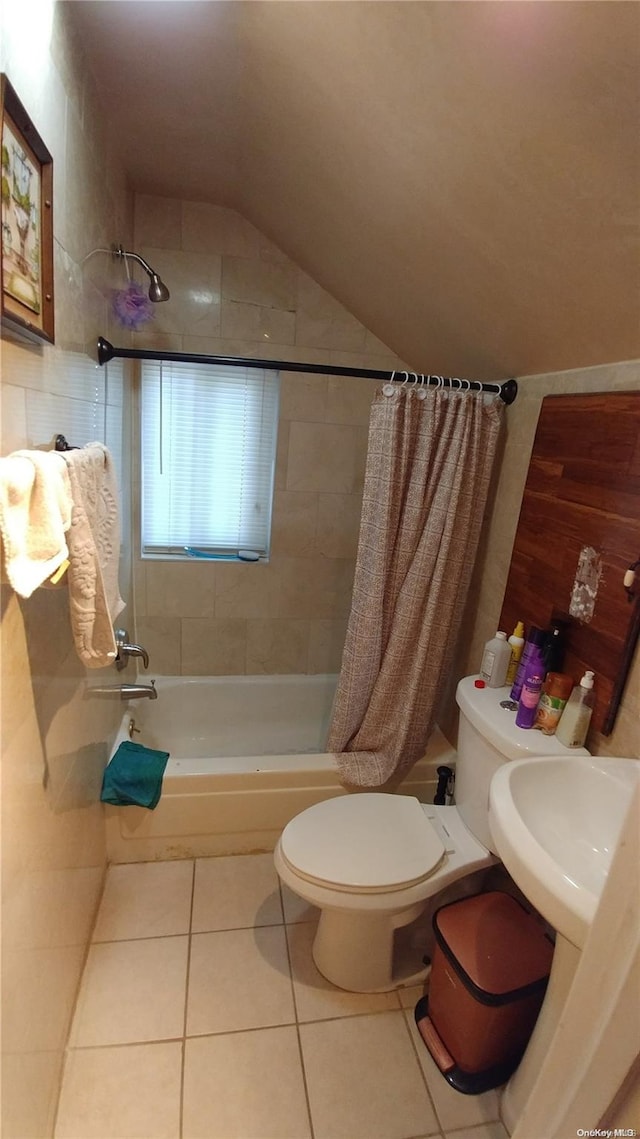 full bathroom with tile patterned floors, lofted ceiling, toilet, shower / tub combo with curtain, and tile walls