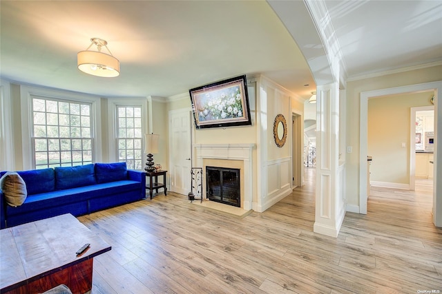 living room with crown molding and light hardwood / wood-style flooring