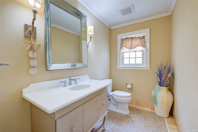 bathroom with tile patterned floors, vanity, toilet, and crown molding