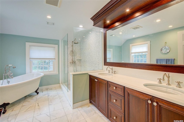 bathroom with vanity and independent shower and bath