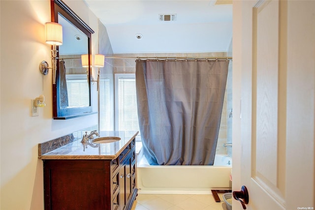 bathroom with tile patterned floors, vanity, and shower / tub combo