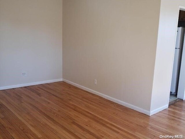 empty room with light hardwood / wood-style flooring