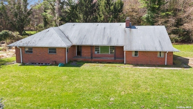 547 Asharoken Ave, Northport, NY 11768 - back of house featuring a yard, brick siding, and a chimney
