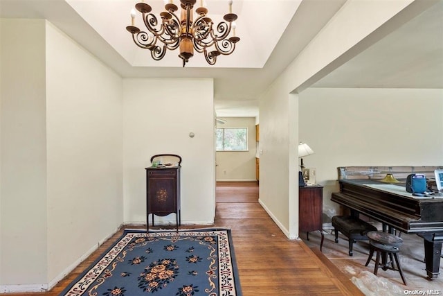 hallway featuring hardwood / wood-style flooring and a notable chandelier