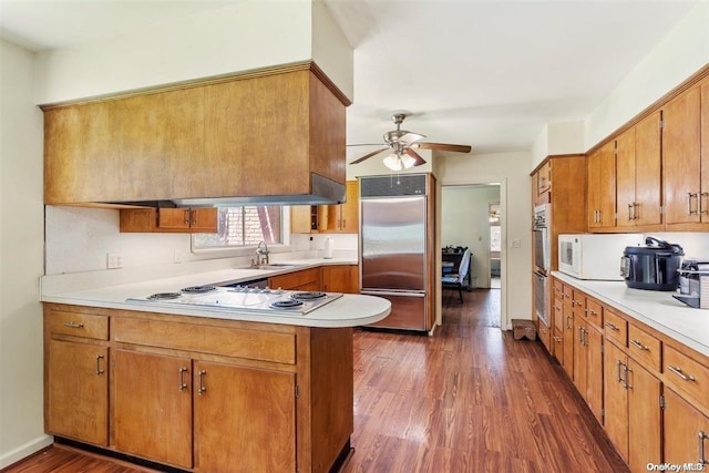 547 Asharoken Ave, Northport, NY 11768 - kitchen featuring stainless steel built in refrigerator, a peninsula, electric cooktop, a ceiling fan, and light countertops