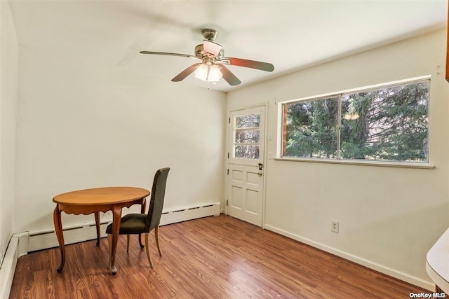 dining space featuring hardwood / wood-style floors, a baseboard radiator, and ceiling fan