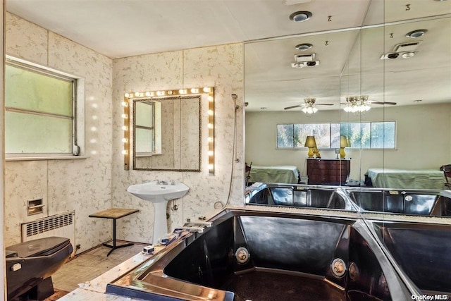 bathroom with radiator, ceiling fan, sink, hardwood / wood-style floors, and toilet