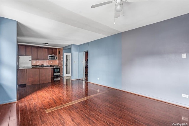 unfurnished living room featuring dark hardwood / wood-style floors and ceiling fan