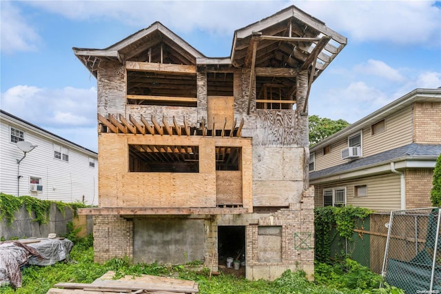 rear view of property featuring cooling unit