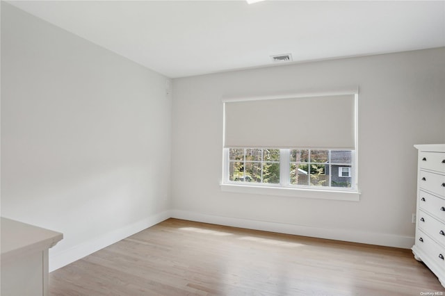 empty room with light hardwood / wood-style flooring