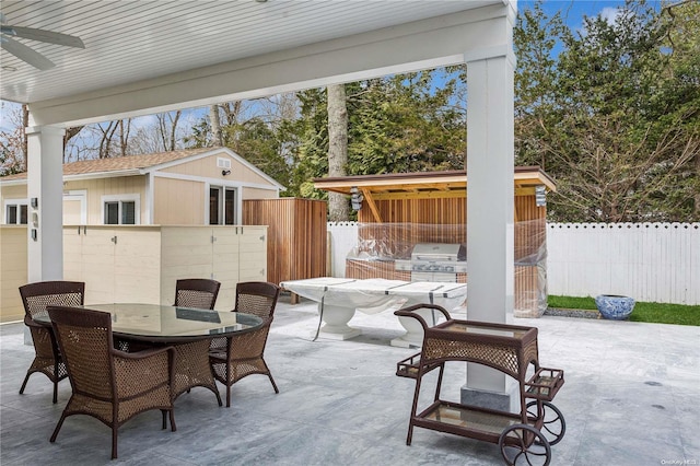 view of patio featuring ceiling fan and a grill