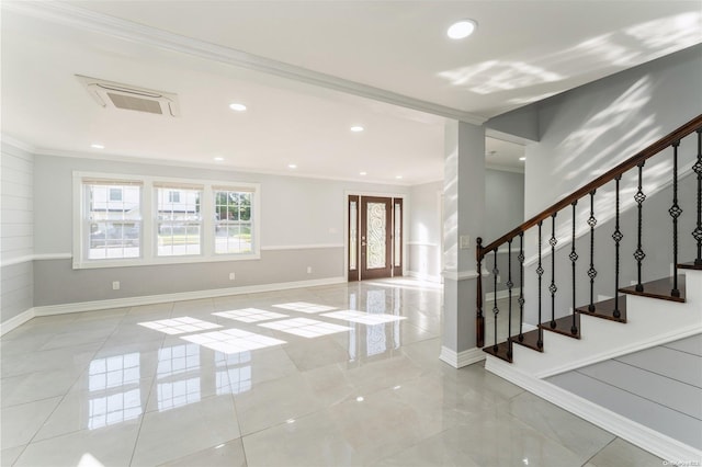 foyer entrance featuring french doors and ornamental molding