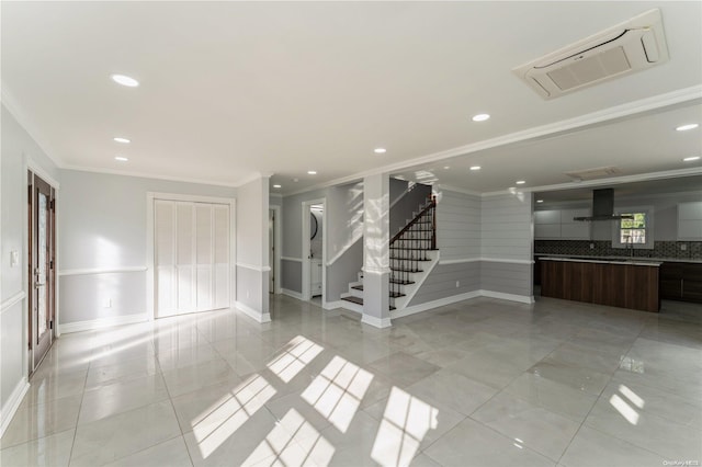 unfurnished room with light tile patterned floors and crown molding