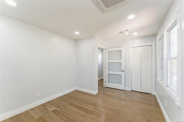 empty room with light hardwood / wood-style floors