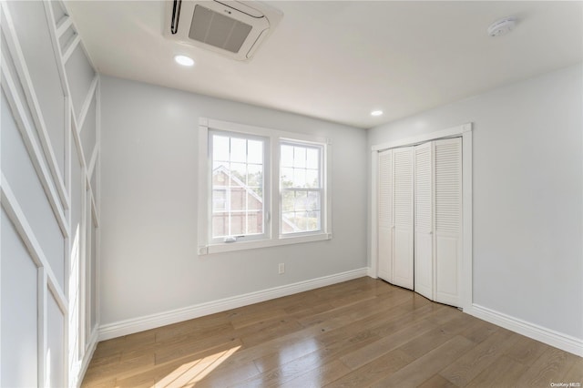 unfurnished bedroom with a closet and light wood-type flooring