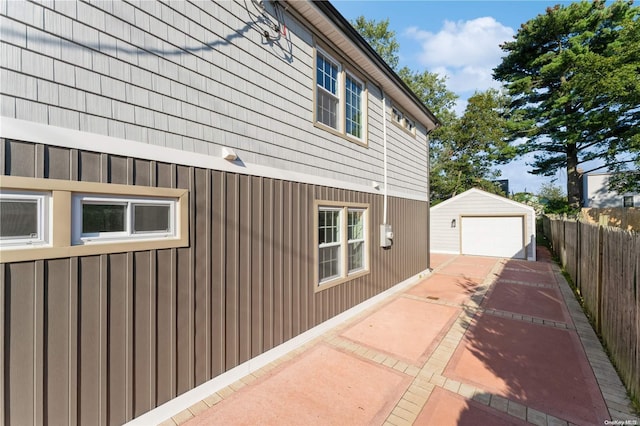 view of home's exterior featuring a garage and an outbuilding