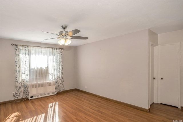 spare room featuring ceiling fan and light wood-type flooring