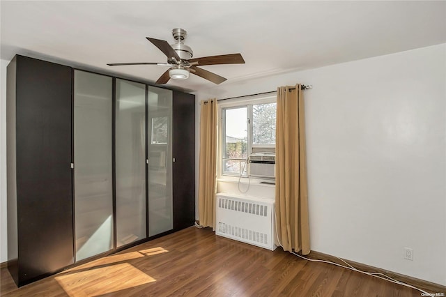 interior space featuring radiator heating unit, dark hardwood / wood-style flooring, and ceiling fan