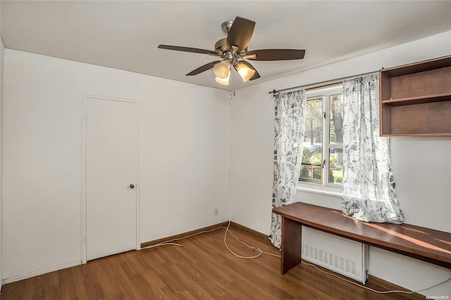 unfurnished bedroom featuring ceiling fan and hardwood / wood-style flooring