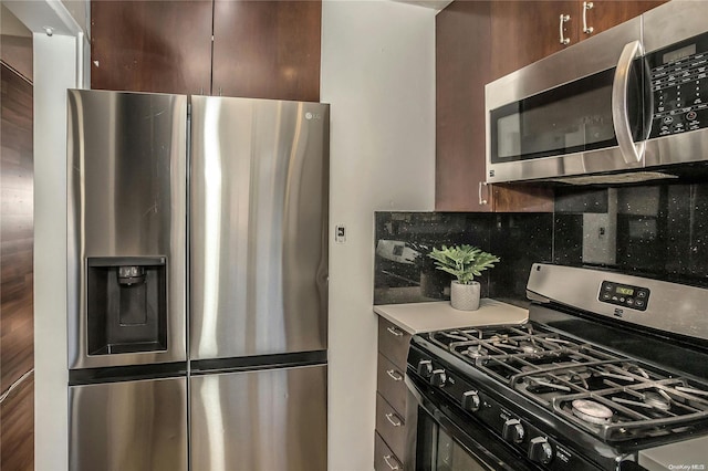 kitchen with appliances with stainless steel finishes, dark brown cabinetry, and tasteful backsplash