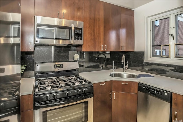 kitchen featuring decorative backsplash, sink, and stainless steel appliances