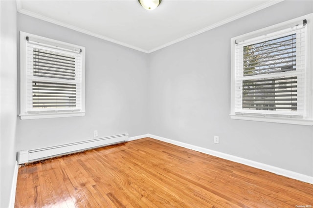 unfurnished room featuring baseboard heating, crown molding, and light hardwood / wood-style floors