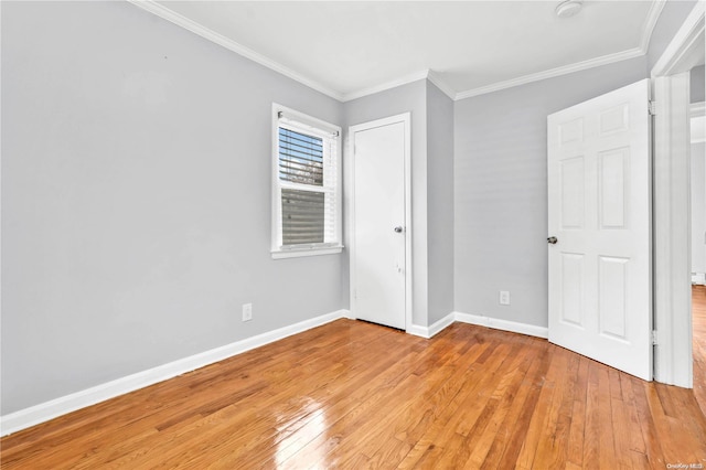 unfurnished bedroom featuring light wood-type flooring and crown molding