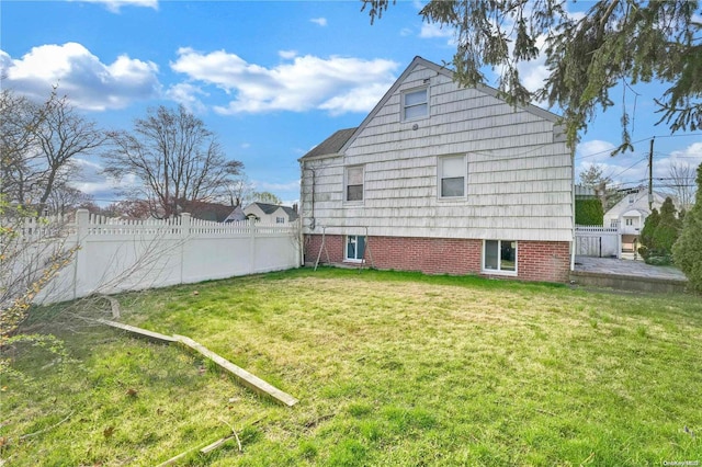 back of property featuring a lawn