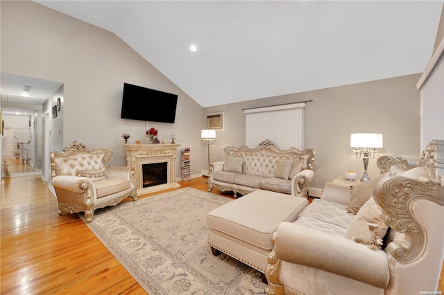 living room featuring hardwood / wood-style flooring and high vaulted ceiling