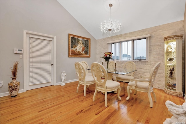 245 W Chester St W, Long Beach, NY 11561 - dining space with lofted ceiling, a chandelier, baseboards, and light wood-style floors