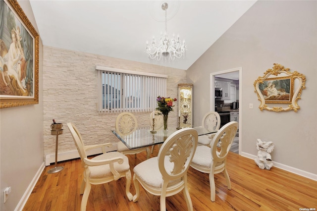245 W Chester St W, Long Beach, NY 11561 - dining space featuring baseboards, wood finished floors, a chandelier, and lofted ceiling