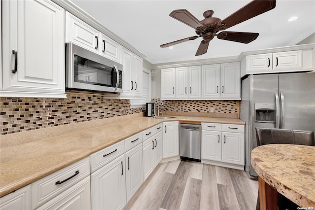 245 W Chester St W, Long Beach, NY 11561 - kitchen with appliances with stainless steel finishes, a sink, white cabinets, recessed lighting, and crown molding