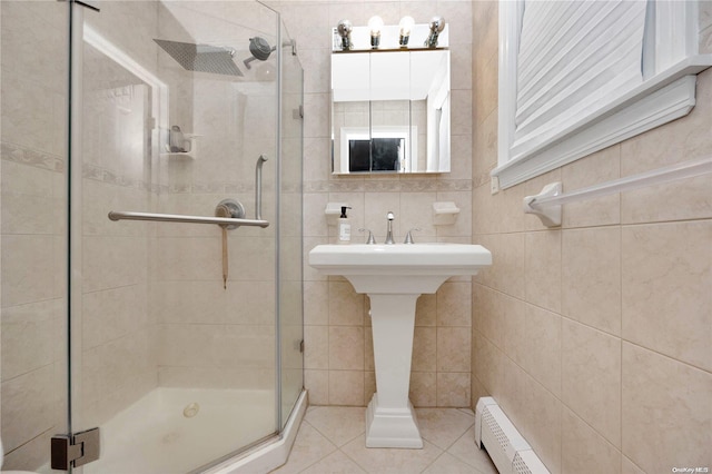 245 W Chester St W, Long Beach, NY 11561 - bathroom featuring a stall shower, tile patterned flooring, tile walls, and a sink