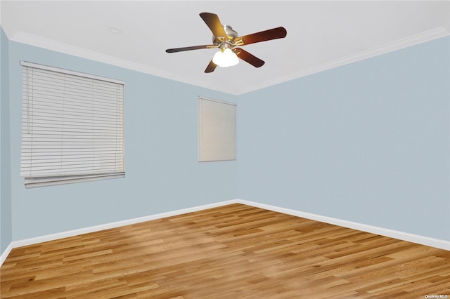 empty room featuring light hardwood / wood-style flooring, ceiling fan, and crown molding