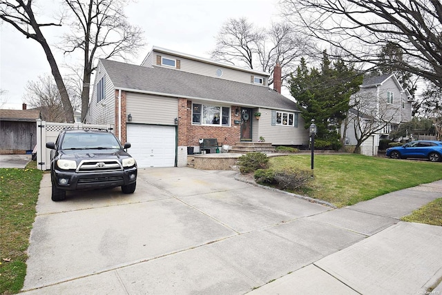 view of front of property featuring a garage and a front yard