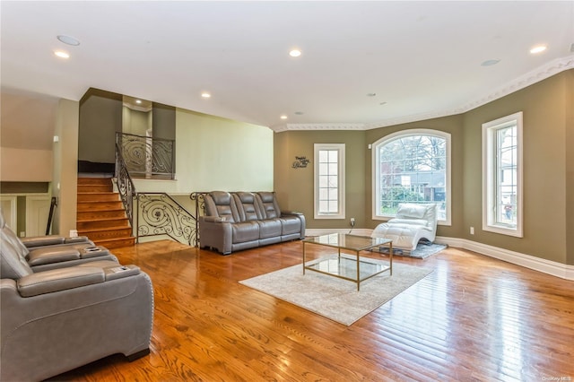 living room with light hardwood / wood-style floors and ornamental molding